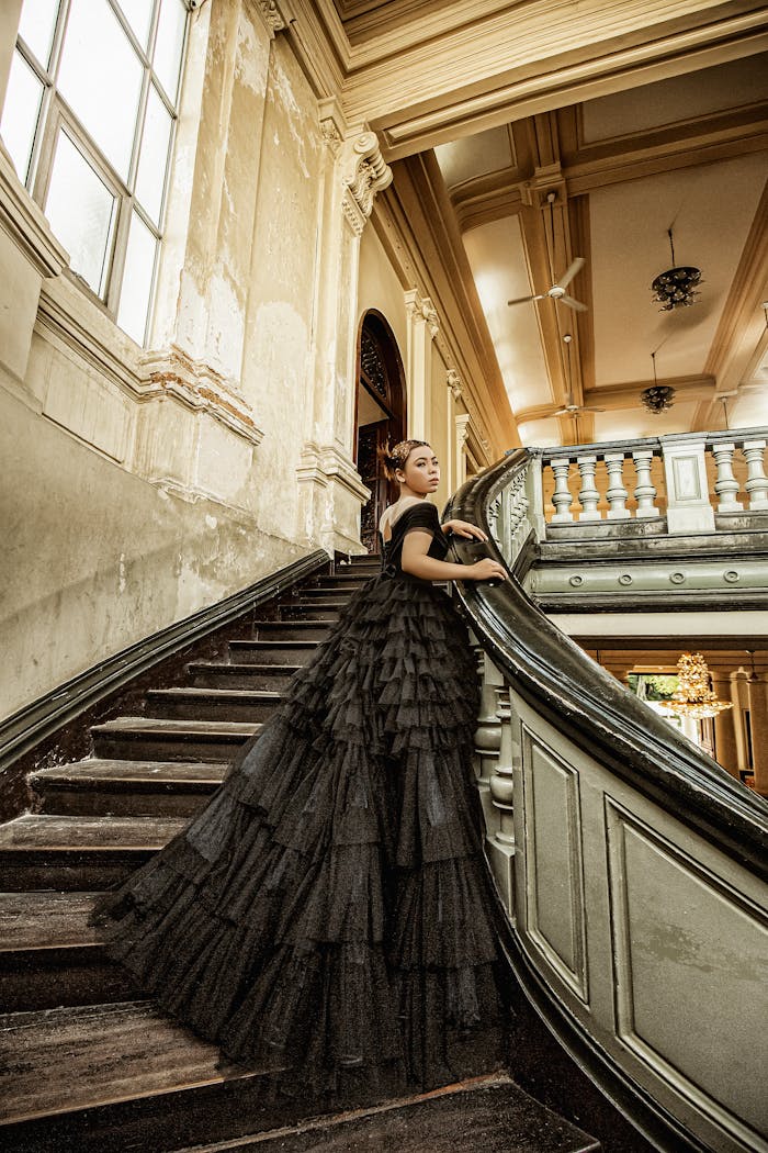 Stunning bridal portrait featuring a woman in a black gown on a classic staircase.